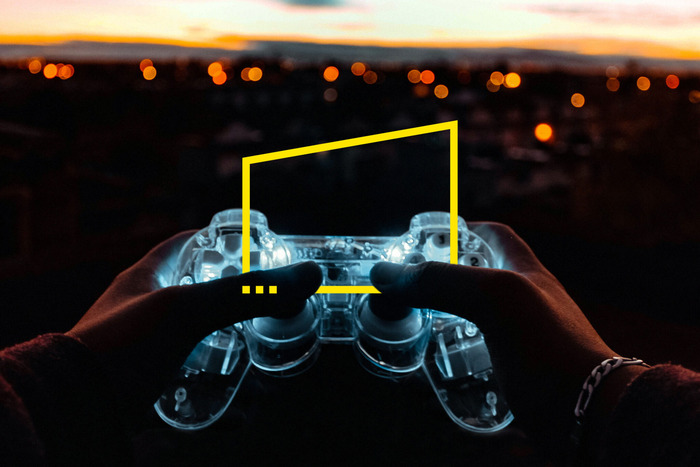 ey hand holding video game controller city night static 2048x1365 1